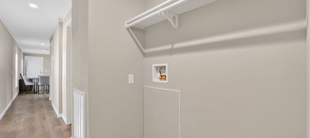 Modern laundry closet with shelf and hanging rod