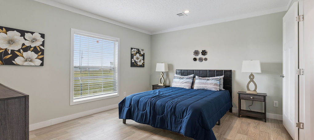 Modern bedroom with blue bedding at The Mill Creek