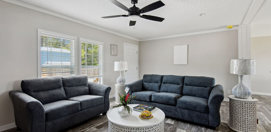 Modern living room with dark gray sofas at The Live Oak.