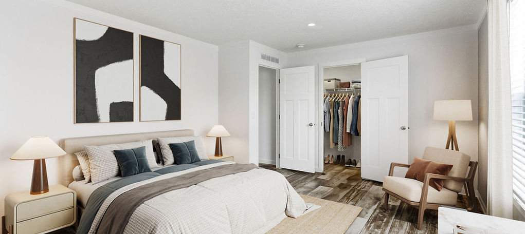 Modern bedroom with large bed, abstract art, and open closet