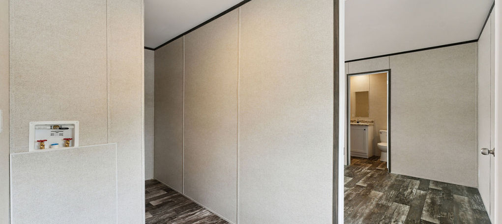 Hallway with utility hookups and bathroom view