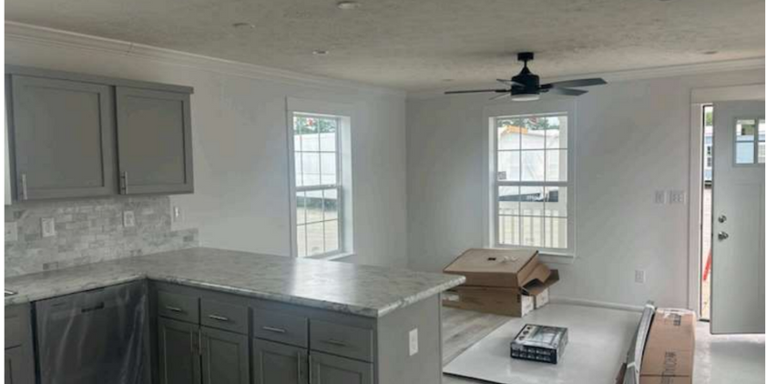 Interior of modern modular ADU with gray kitchen cabinets