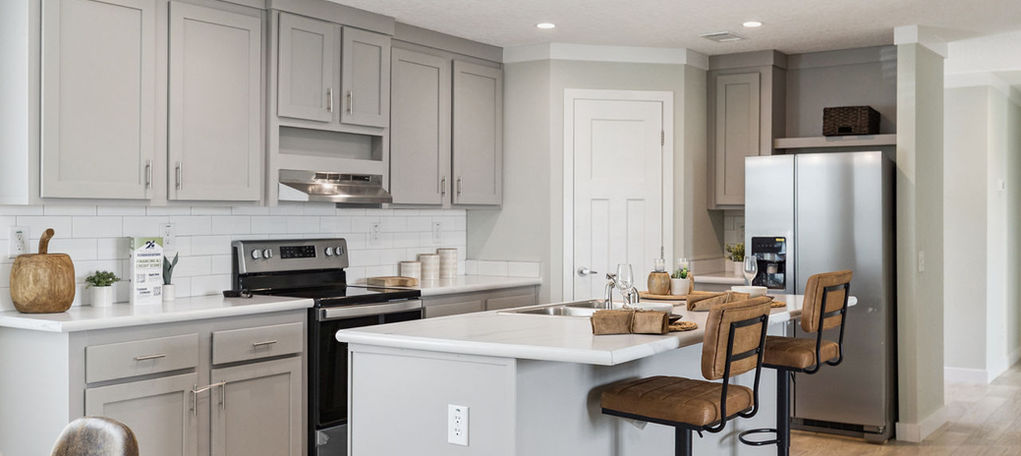 Modern kitchen with grey cabinets and stainless steel appliances