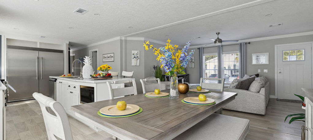 Modern open-concept dining and living area with white decor
