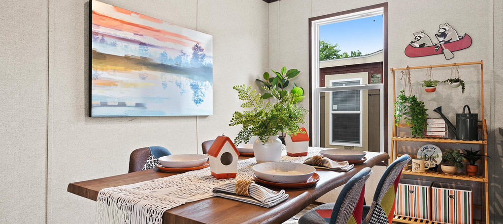 Modern dining room with colorful chairs and abstract art