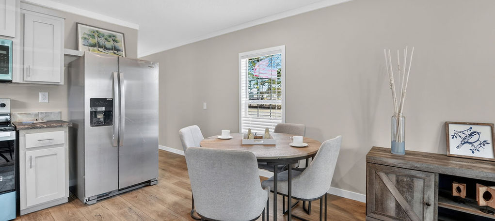 Modern kitchen and dining area with stainless steel fridge