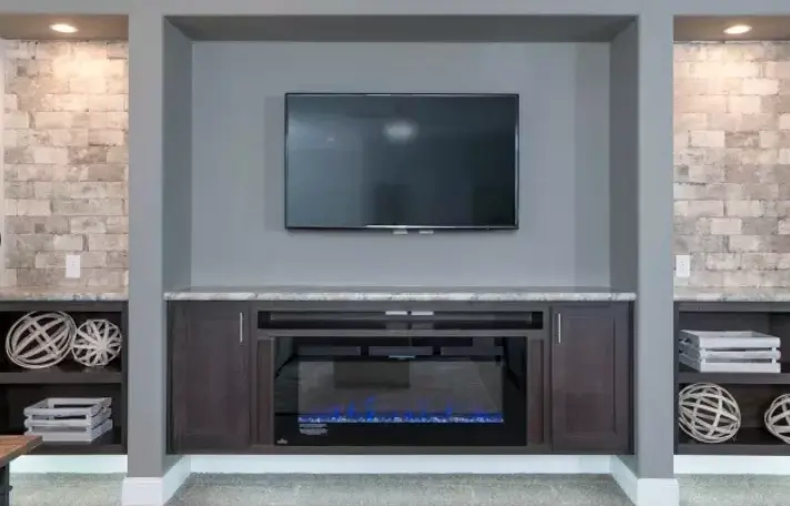 Integrated media center with TV, fireplace, and decorative shelving