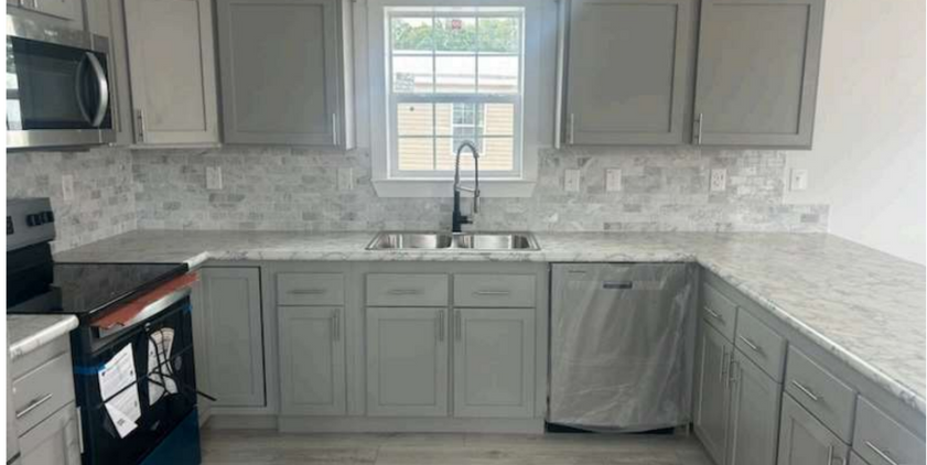 New kitchen with gray cabinets and white countertops
