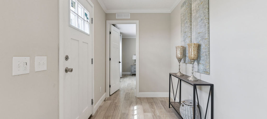 Modern home entryway at The Bluebird with wood floors.