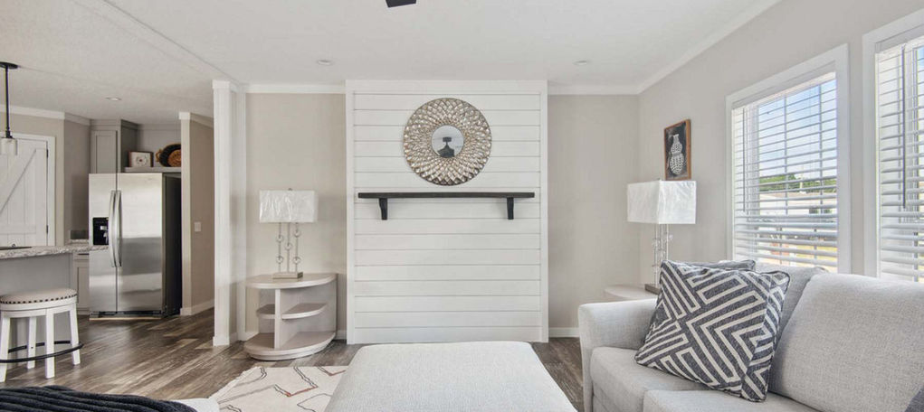 Modern living room with shiplap wall and ceiling fan