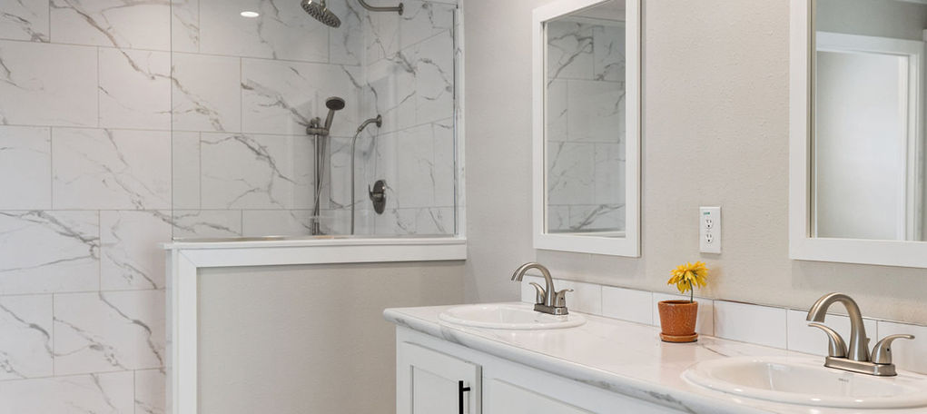 Modern white bathroom with double vanity and marble shower