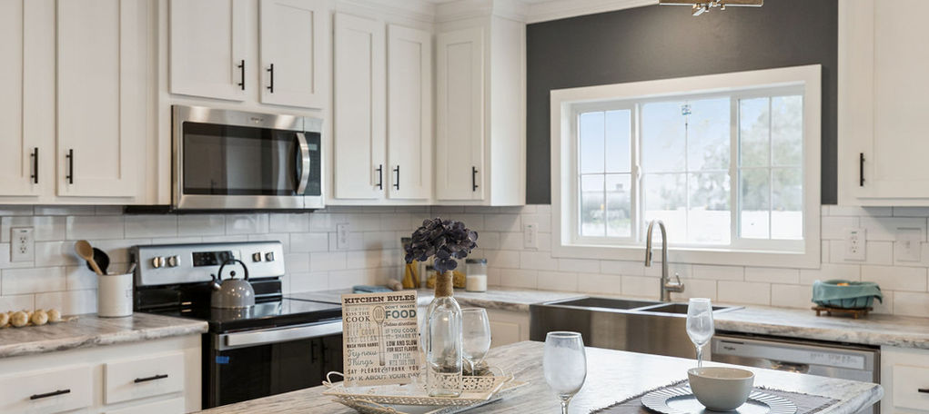 Modern kitchen with white cabinets and marble island