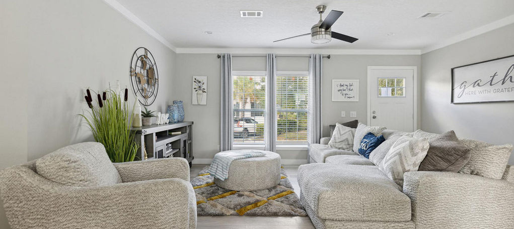 Modern living room at The Southport with gray sofas.