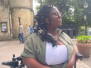 Mary is sat by a  coffee table in York park