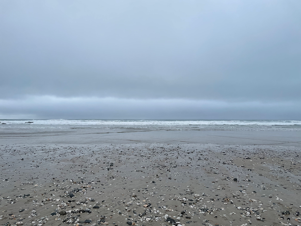 Sea and sand at Porthtowan beach in Cornwall on a drizzly day
