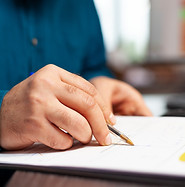 closeup-businessman-hand-sitting-desk-analyzing-document-with-data-chart-it-working-manage