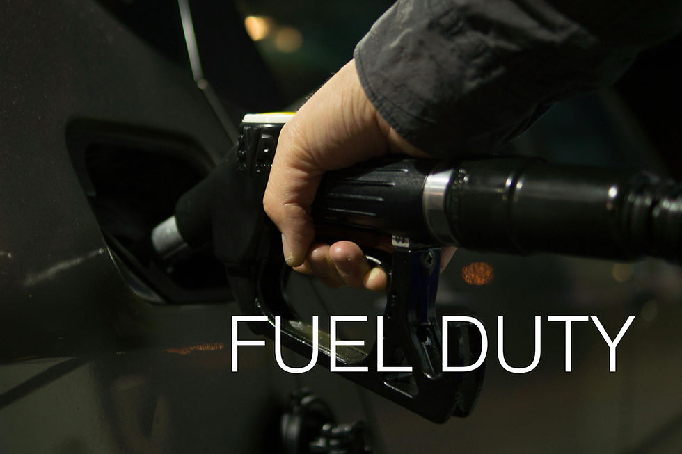 Hand holding a fuel pump nozzle refueling a car under dim lighting.