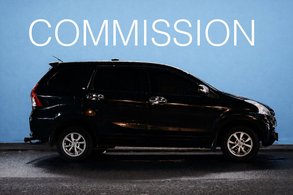 Black car parked on wet pavement against a blue wall. The word "COMMISSION" is prominently displayed above in large white letters.