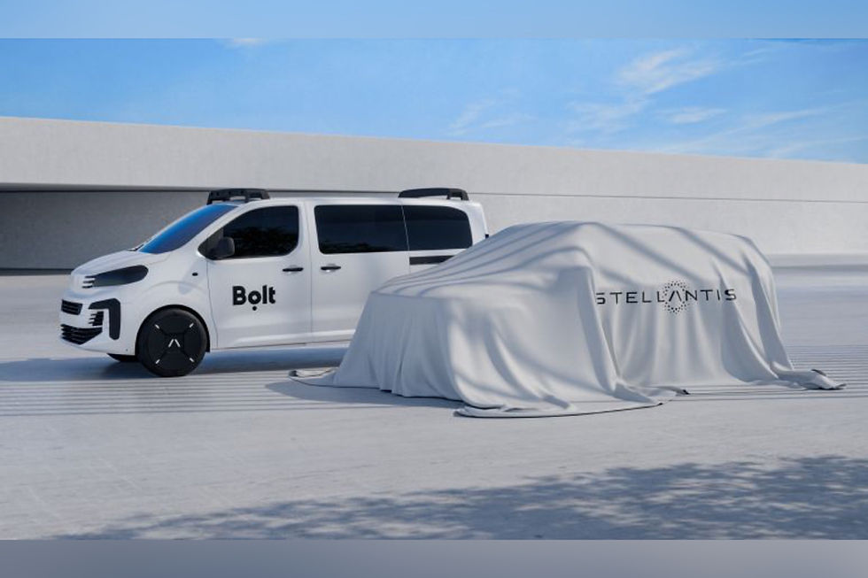 White van labeled "Bolt" parked beside a covered vehicle with "Stellantis" text. Modern setting, clear skies, minimalistic design.