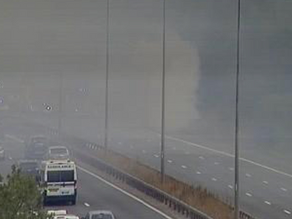 Taxi on fire smothers motorway in smoke causing delays on M11 in Essex
