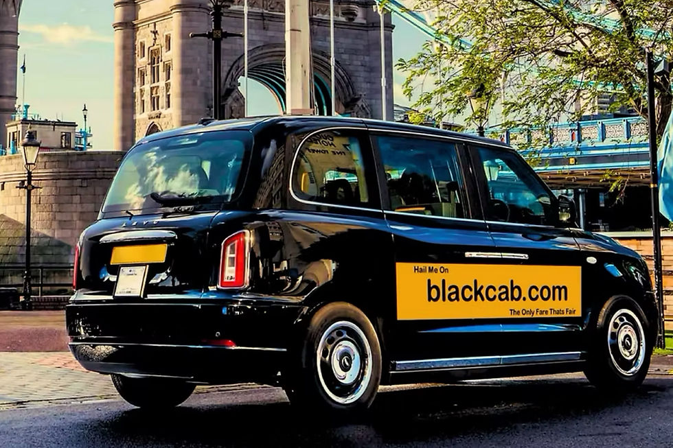 Black taxi with "blackcab.com" ad parked near historic stone bridge and trees, under a partly cloudy sky. Sunny and vibrant setting.