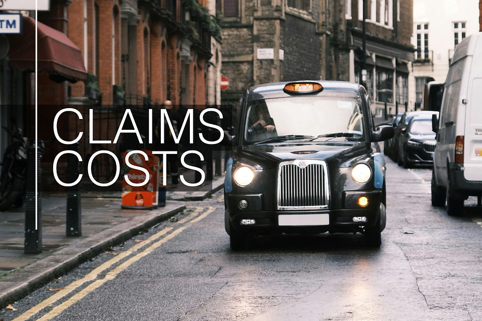Black taxi driving on a narrow, wet street with red-brick buildings. Urban setting with muted tones.