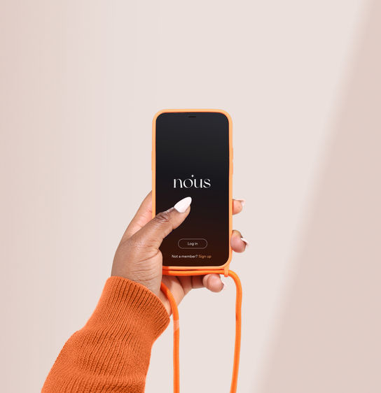 Hand holding orange phone with the word