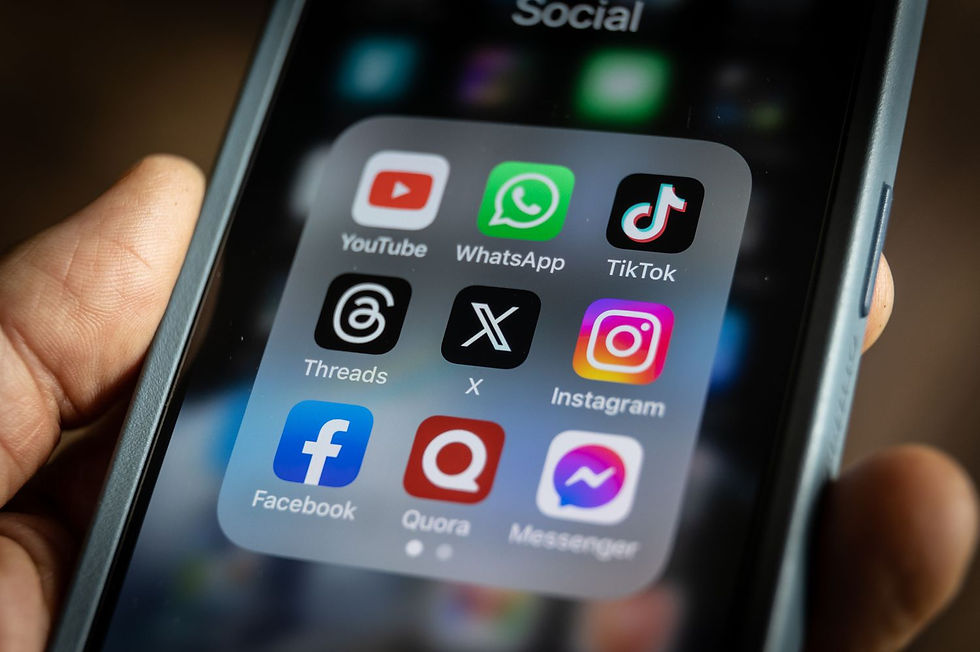 A person holding a smartphone displaying an online social media community group for Atlanta rentals