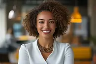 A professional portrait of a smiling woman, representing a dedicated buyer's agent helping clients hire a realtor to buy a house