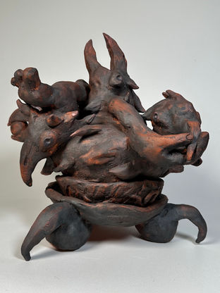 A terracotta statue of birds and human hands mixed together