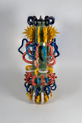 A ceramic sculpture with lots of handles varying in shape, size and color