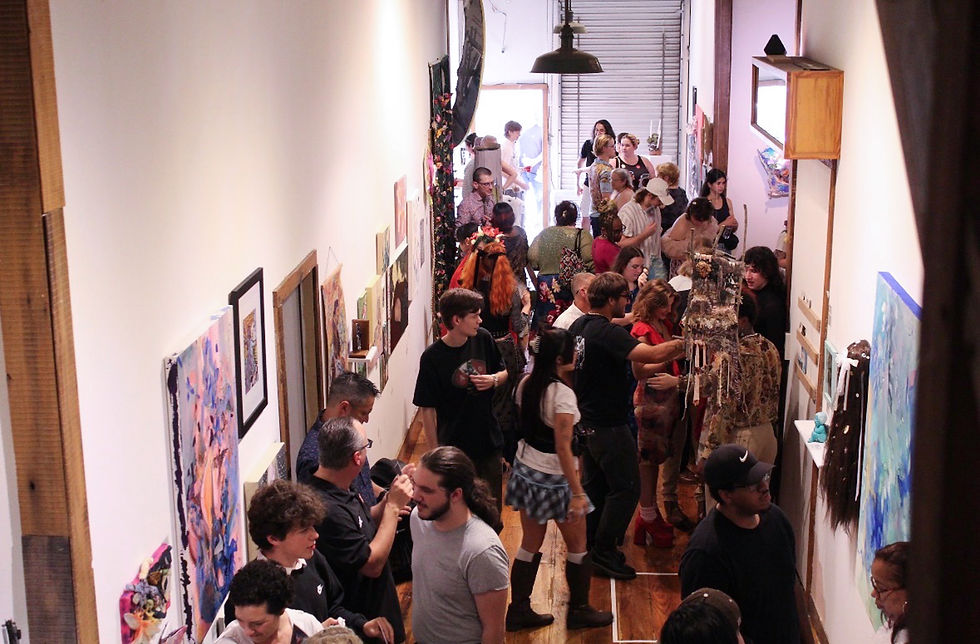A crowd of people at the ARCHIVES: whimsy Opening Reception in the Hallway Gallery