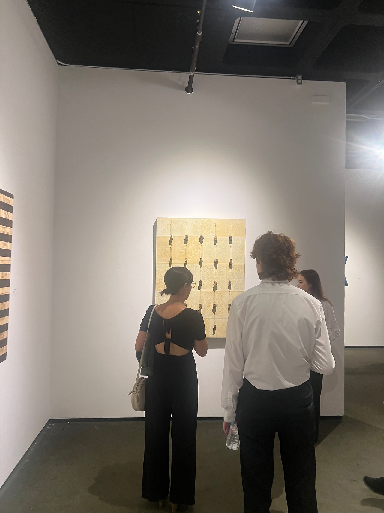 IT Coordinator Red Landry and Artist Liaison Carley Dupre view a ULL Visual Arts student's studio space