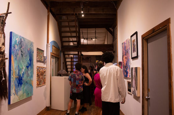 People in a hallway full of art at at ARCHIVES: whimsy