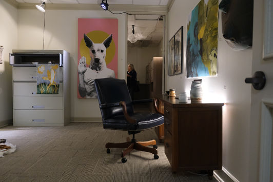 Several pieces of fine art are installed in an office space, with a filing cabinet and a desk being utilized in the installation.  From the left, the artists are Sheldon Blue, Louis Deumite, Todd Gardiner, Lauren Baquet, Red Landry, Bethany Lejeune and Chris Pate