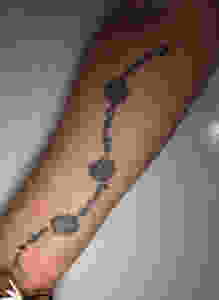 A tattoo with four names and four flowers