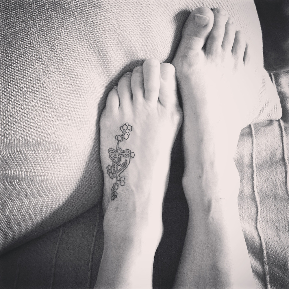 Tattoo on a foot. Black and white.