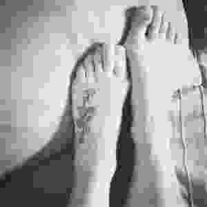 Tattoo on a foot. Black and white.