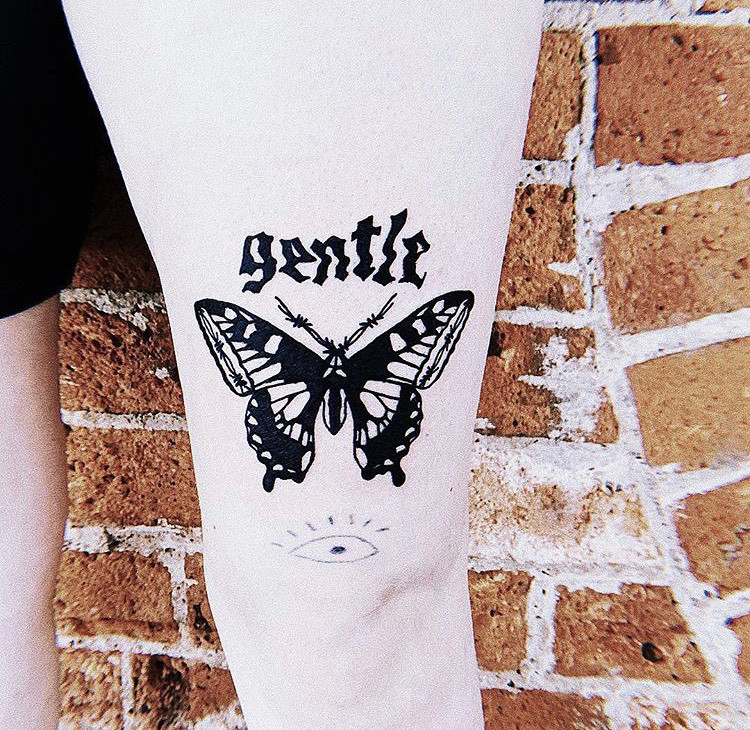 Tattoo of a butterfly and the word gentle