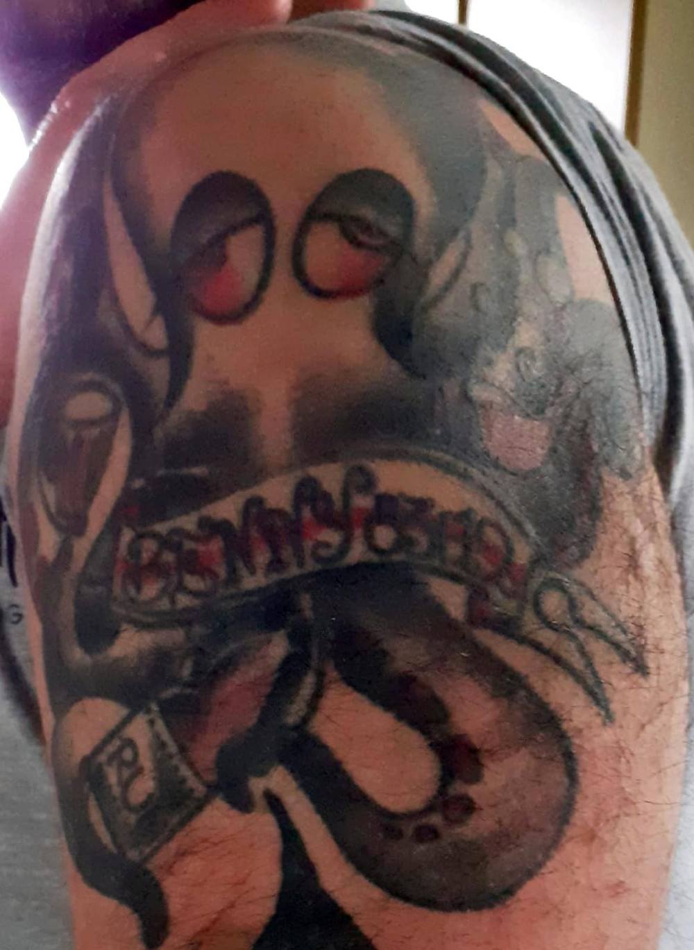 Tattoo of an octopus on an upper arm