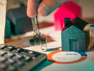 Calculator, key and model house