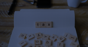 Tax spelt out with tiles on a book