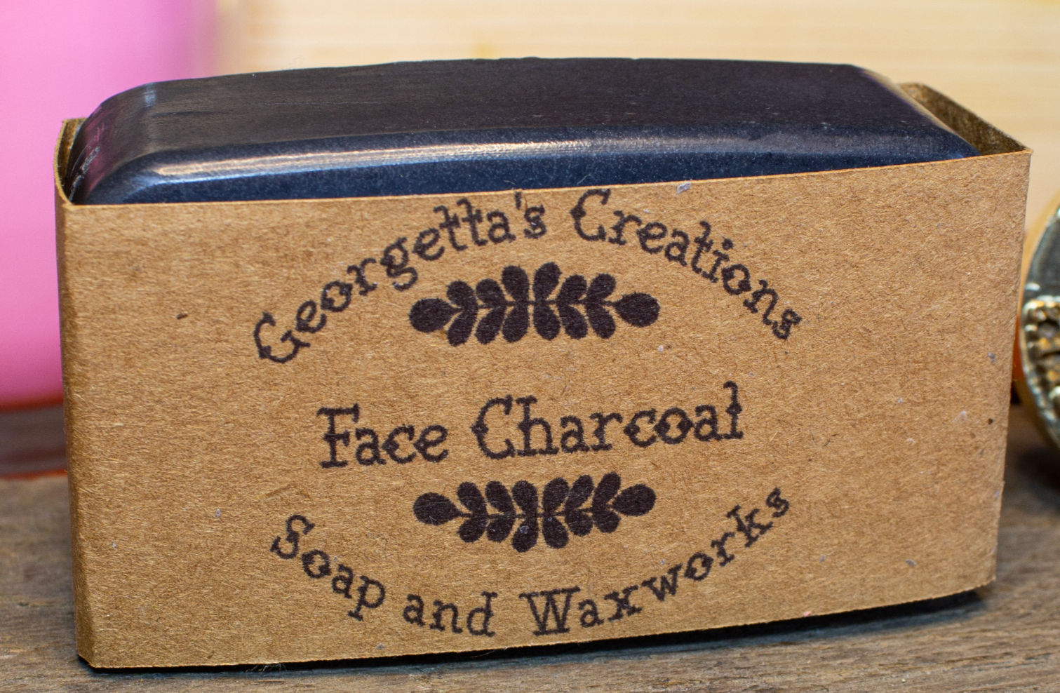 Georgetta's Creations Face Charcoal Soap and Waxworks product label on brown paper.