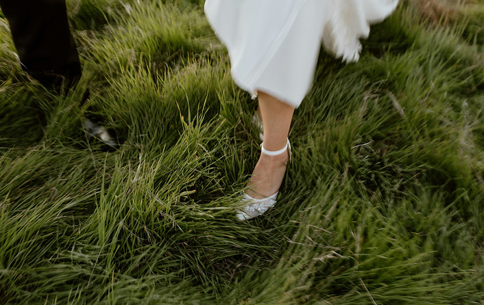 Bride running in the grass