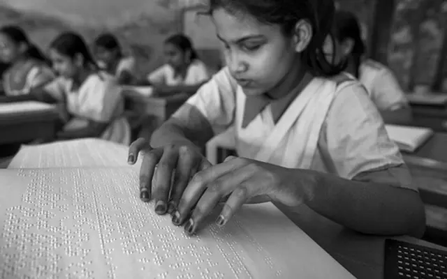 blind-girl-reading-braille.webp