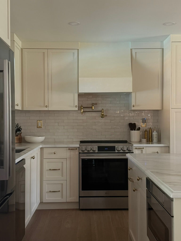 Kitchen with painted cabinetry and trim, illustrating satin paint sheen on millwork and cabinets.
