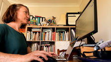 Morven Hamilton, yoga teacher, types on a laptop creating original marketing content