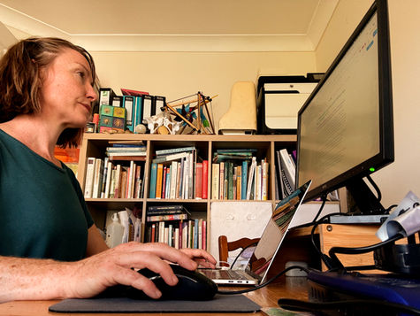 Morven Hamilton, yoga teacher, types on a laptop creating original marketing content