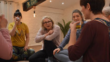 200 hour yoga course participants drinking tea, chatting and laughing in the yoga studio