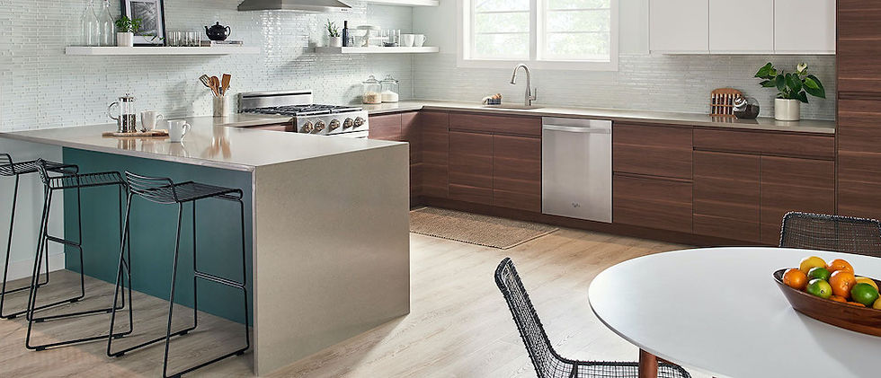 Modern kitchen with walnut slab-door cabinets, a teal peninsula base and a warm sand-colored quartz countertop with a waterfall edge